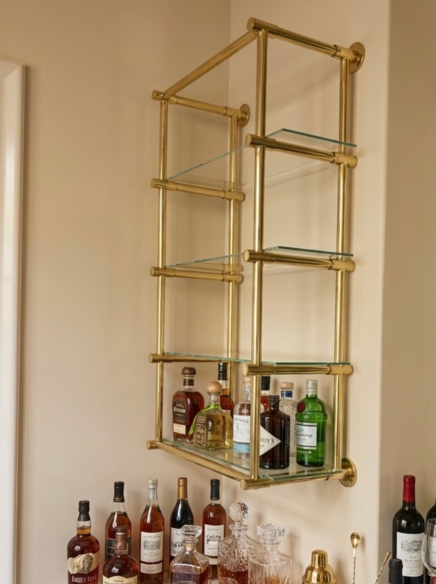 Brass wall shelving with glass shelves